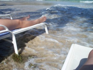 Lounge chairs on the beach, and in the waves